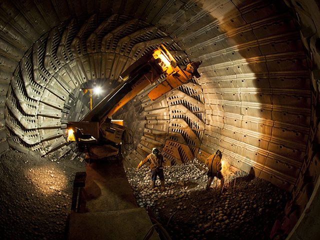 Kaltech workers inside a mill with lights