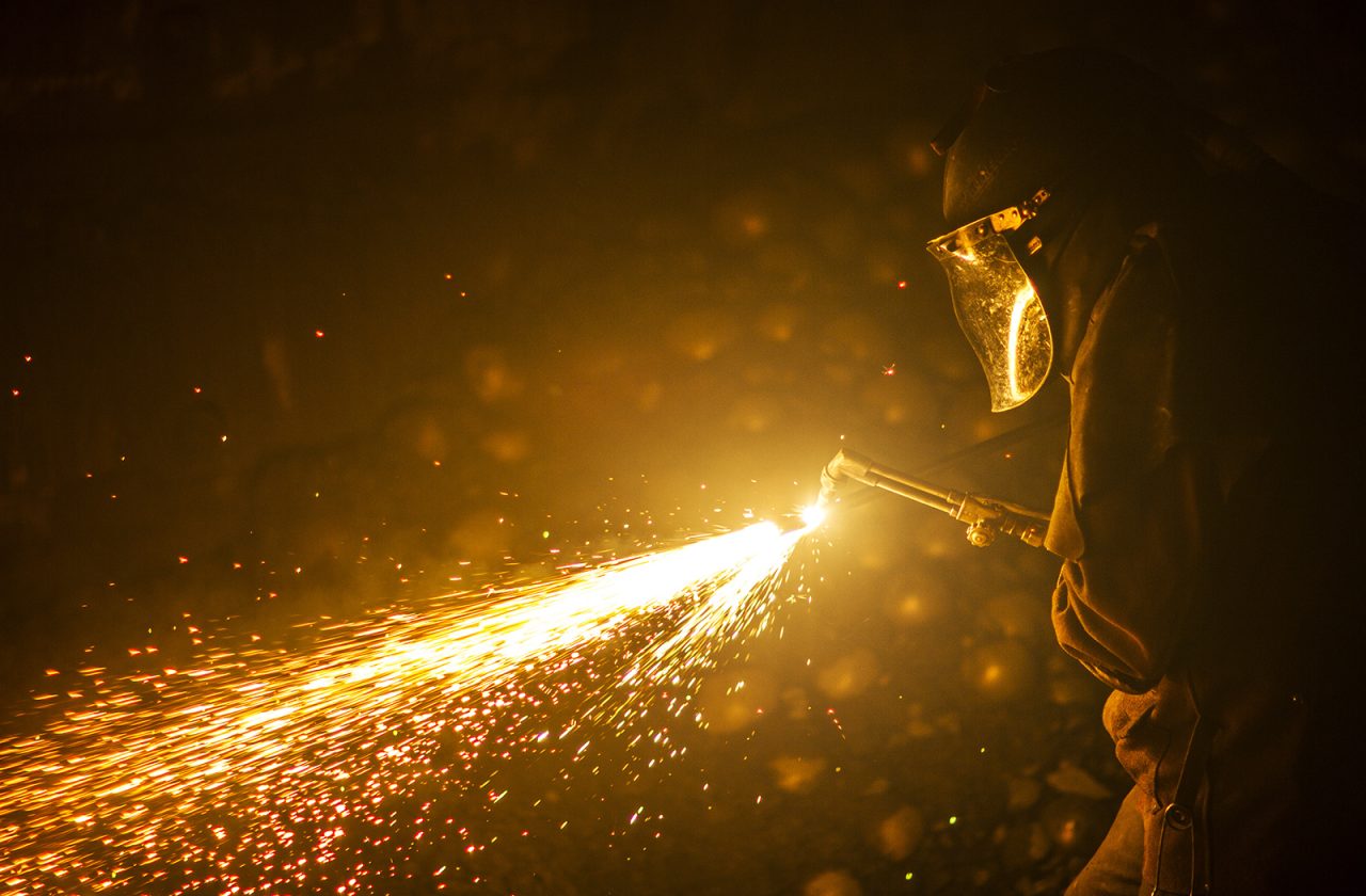 Kaltech worker with sparks in a mill