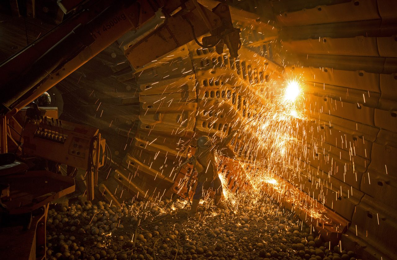 Kaltech worker inside a mill with a shower of sparks