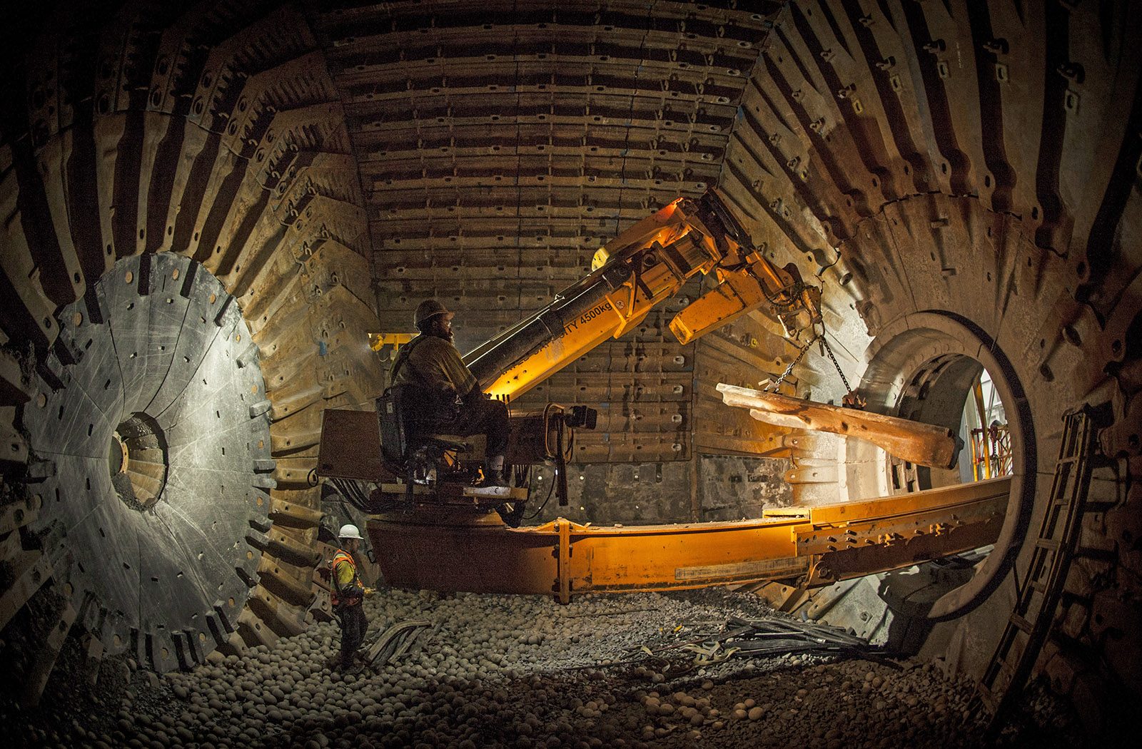 Kaltech workers inside a mill with large equipment