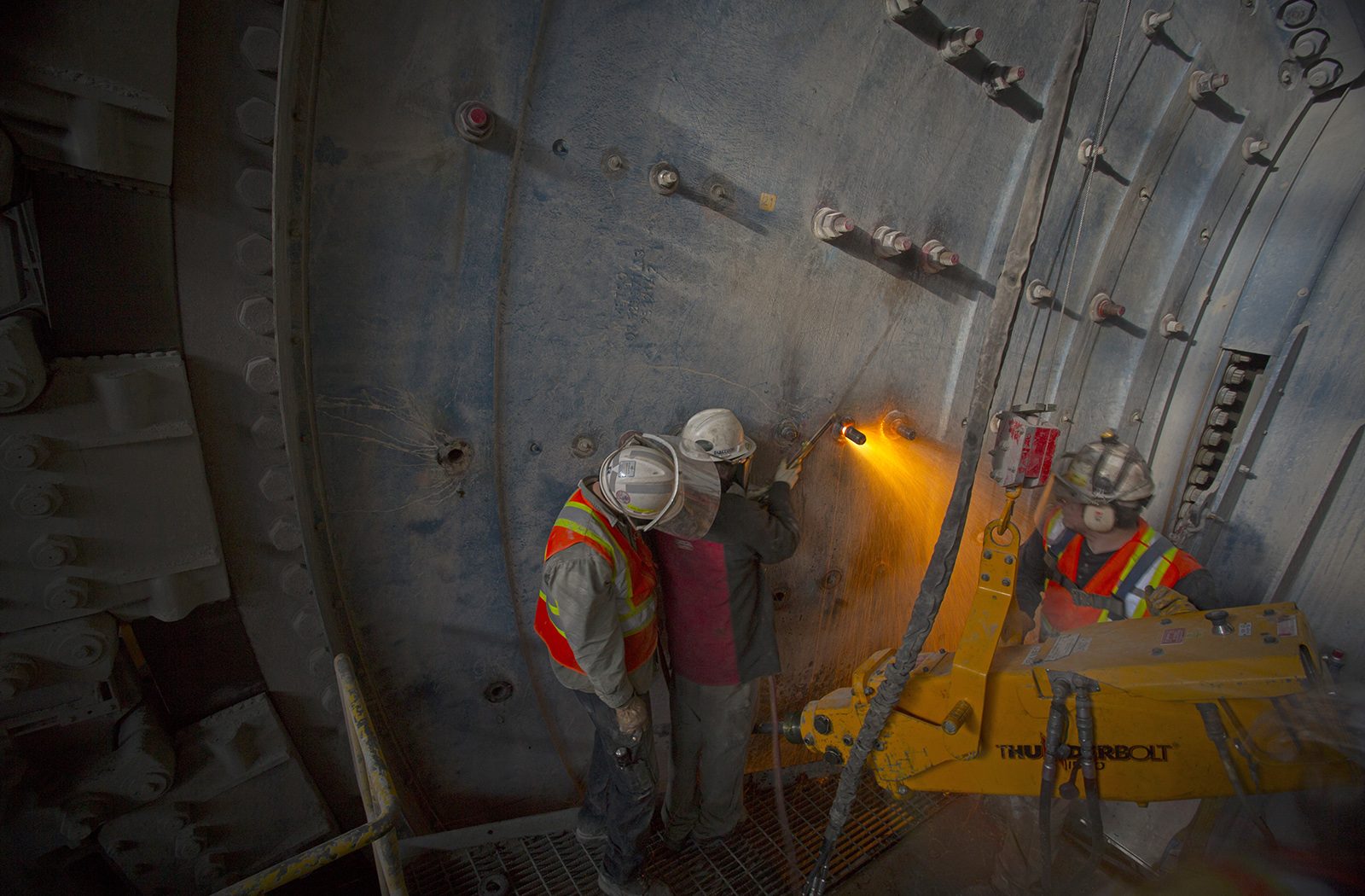 Kaltech workers doing close work on the outside of a mill