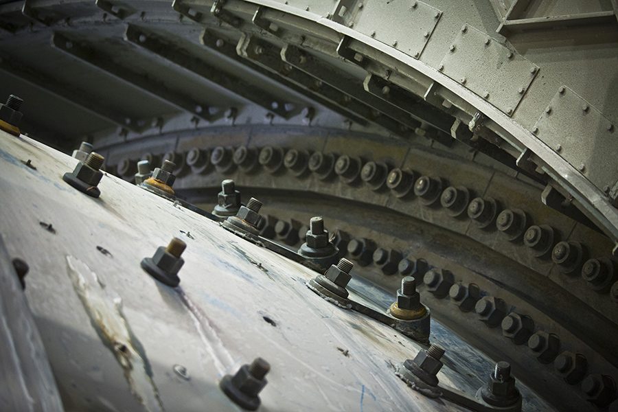 Close-up of a mill liner section with rows of bolts