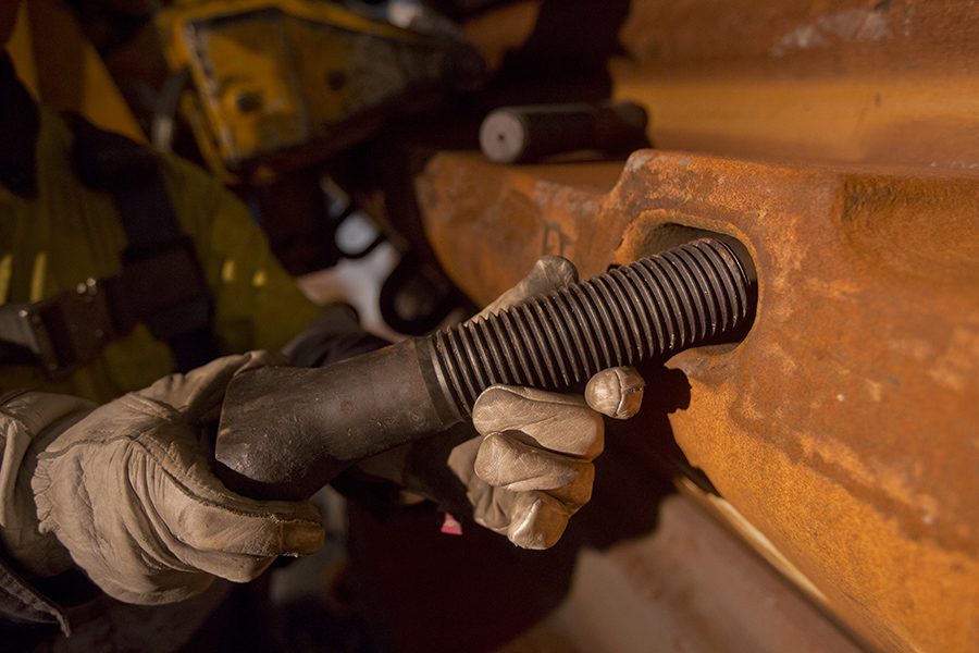 Kaltech worker installing a mill liner bolt