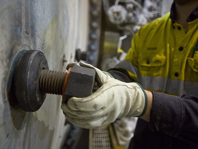 Kaltech worker changing a mill liner bolt